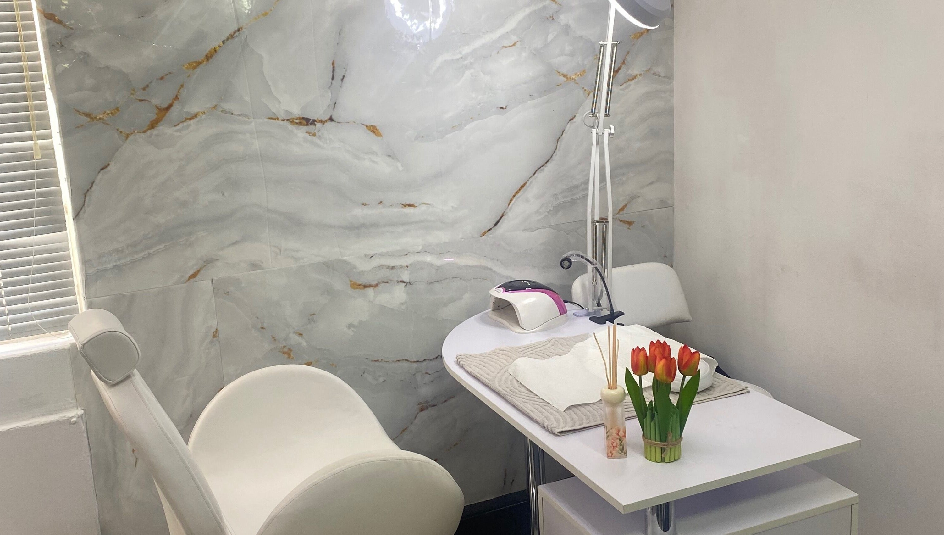 Elegant nail treatment area at Mashobalee Spa Lounge, Sandton, Gauteng, ZA with modern decor and tulip accents.