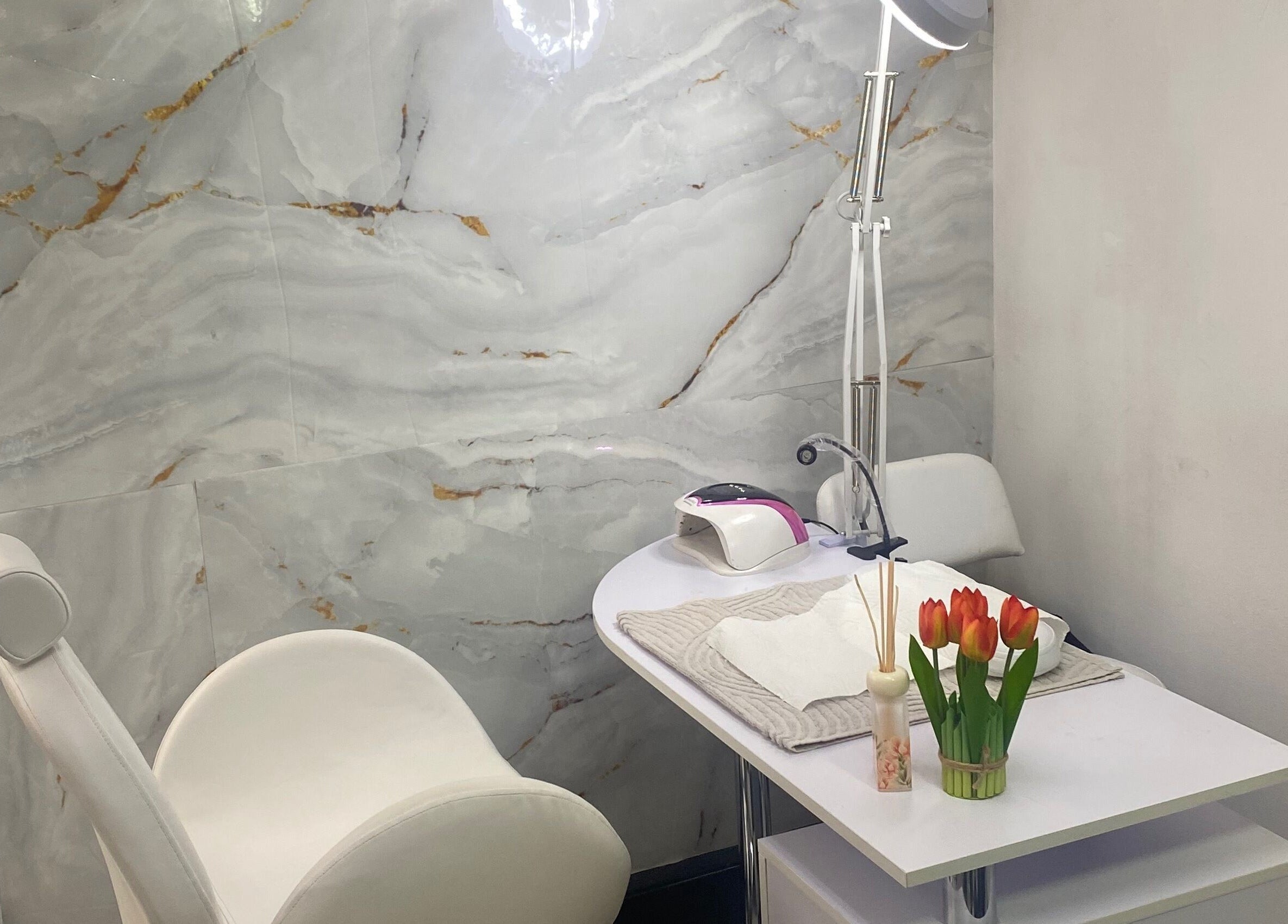 Elegant nail treatment area at Mashobalee Spa Lounge, Sandton, Gauteng, ZA with modern decor and tulip accents.