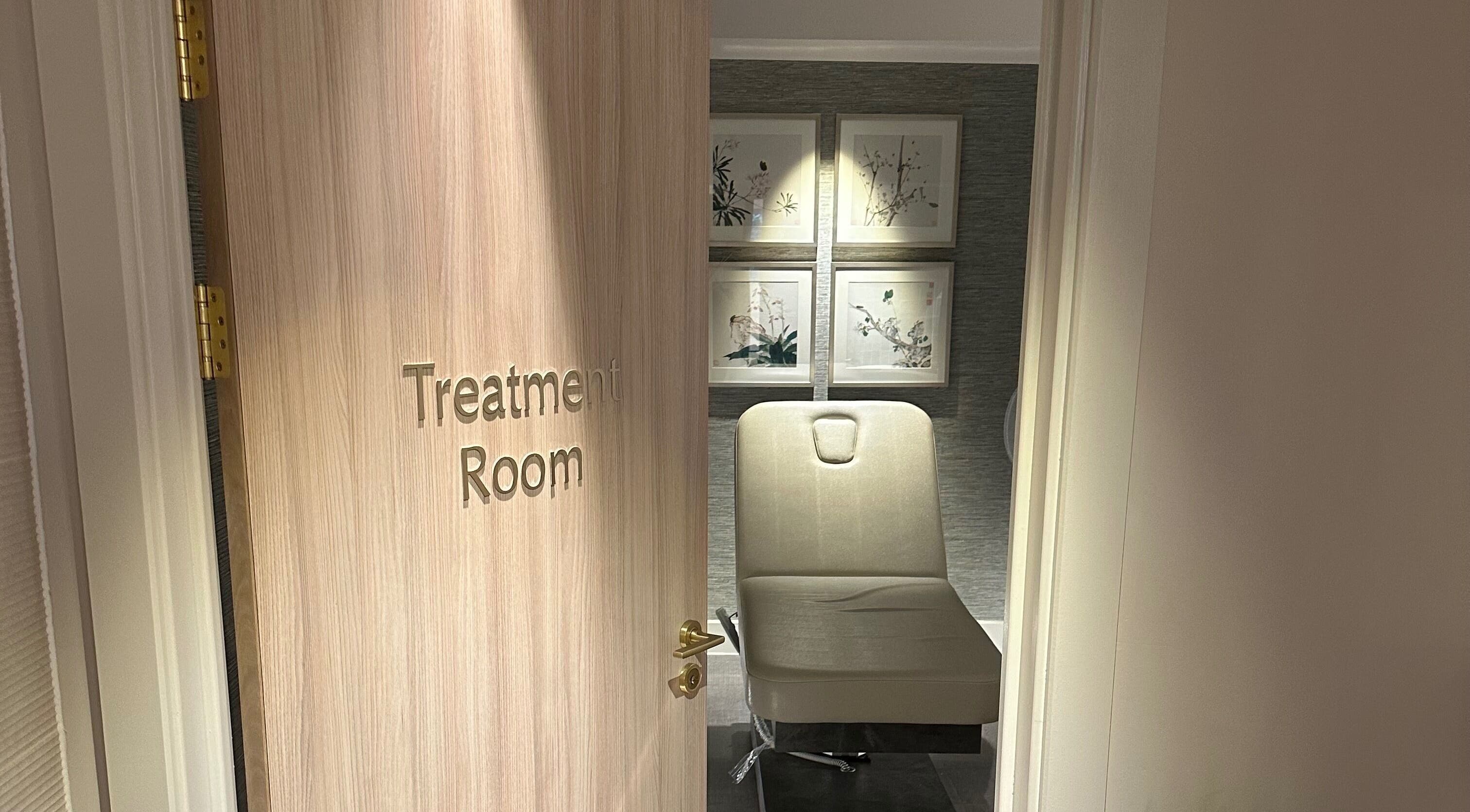 Reflex Harmony treatment room in Cirencester, England, GB showing a cozy chair and calming decor.
