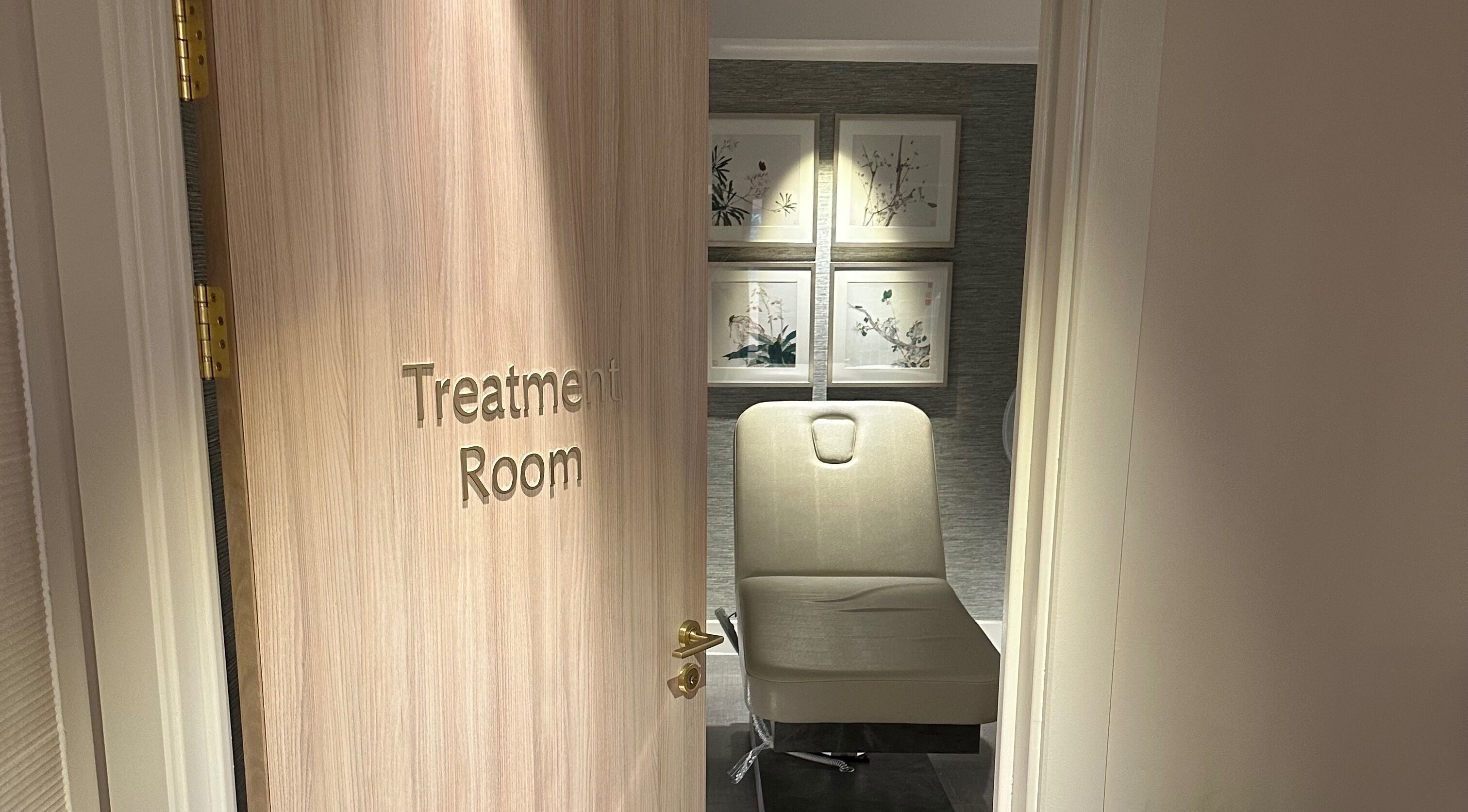 Reflex Harmony treatment room in Cirencester, England, GB showing a cozy chair and calming decor.