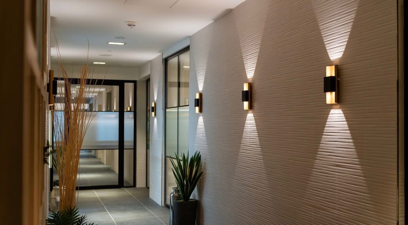 Elegant hallway at Reflex Harmony, Cirencester, England, GB, showcasing modern lighting and decor.
