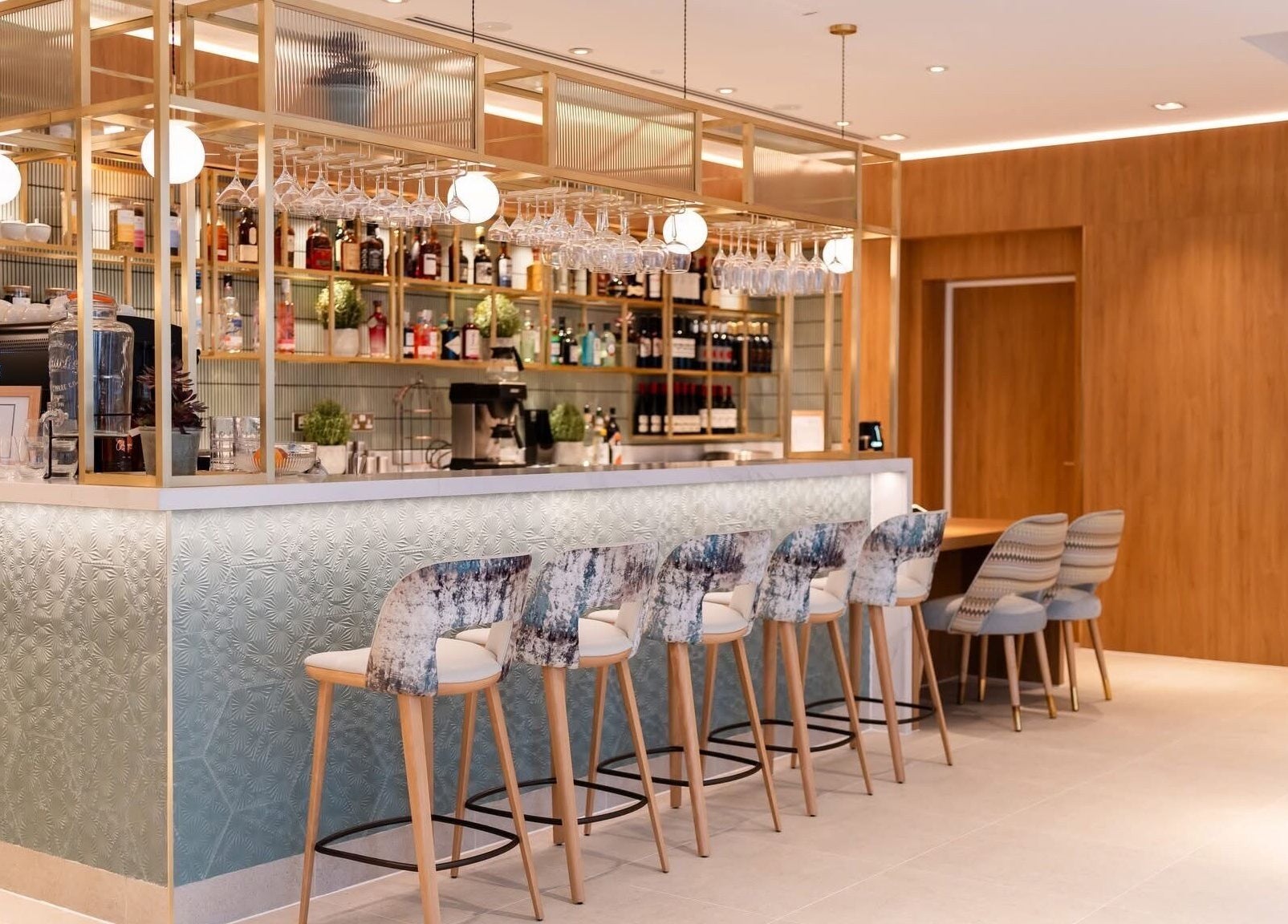 Stylish bar area at Reflex Harmony, Cirencester, England, GB with modern seating and elegant design.