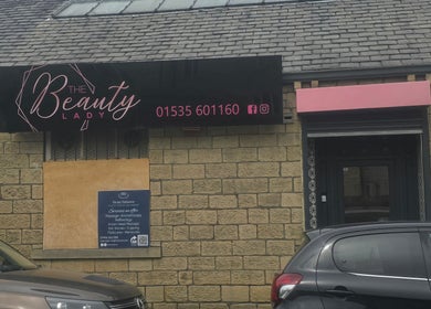 The Nail Angel exterior, elegant facade in Bingley, England, GB, sign in pink and black.
