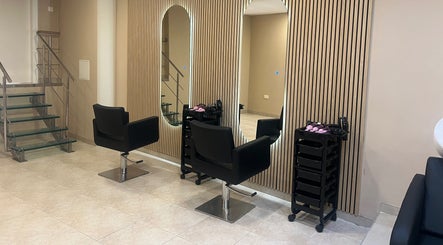 Elegant salon interior at The Beauty Lab in Ħal Qormi, MT, featuring sleek black chairs and modern decor.