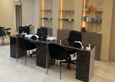 The Beauty Lab in Ħal Qormi, MT features a modern, stylish manicure station with sleek chairs and elegant decor.