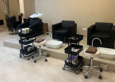Modern salon interior at The Beauty Lab, Ħal Qormi, MT with plush seating and sleek hair styling stations.