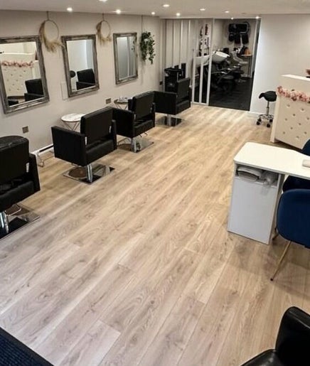 Modern interior of DYN NAILSROOM, Mold, Wales, GB, featuring stylish chairs and mirrors.