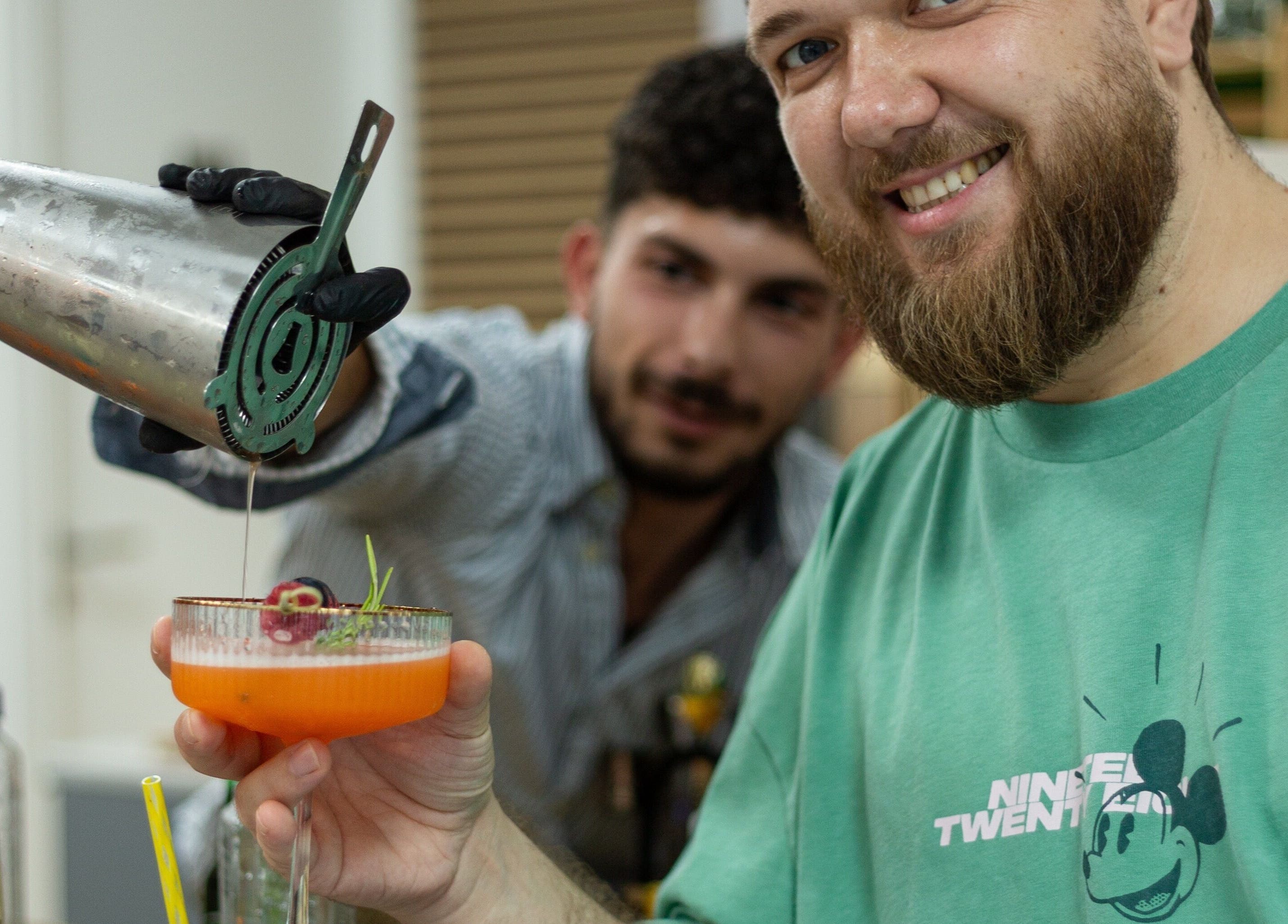 Bartender crafting a cocktail at 3rd Generation London, Timișoara, Județul Timiș, RO, with a joyful customer.