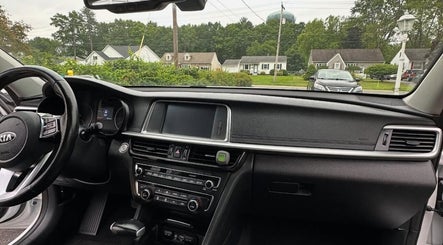 Car interior at REDEFINE AUTO DETAILING, LLC, Albany, New York, US showcases a pristine dashboard and steering wheel.