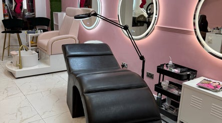 Luxurious treatment room at Nicole’s Dolls House, London, England, GB with plush chair and sleek decor. 