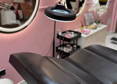 Luxury treatment bed at Nicole’s Dolls House, London, England, GB, with soft pink aesthetic.