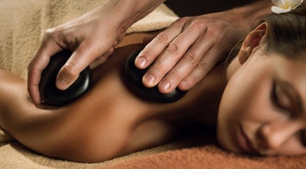 Relaxing hot stone massage at AMATA MASSAGE STUDIO in Toronto, Ontario, CA offering soothing wellness treatments.