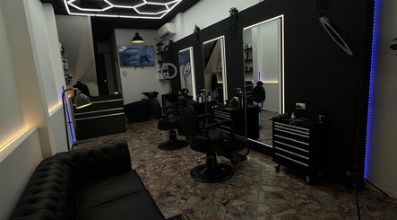 Stylish interior of DEEP HAIR premium cut & shave in Romano Di Lombardia, Lombardia, IT. Modern barbershop chairs and decor.