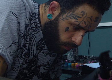 Artist at Liverpool Tattoos Orrell Park creating intricate tattoo in Liverpool, England, GB.