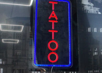 Neon tattoo sign at Liverpool Tattoos Orrell Park, located in Liverpool, England, GB.