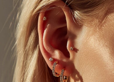 Stylish ear piercings at Liverpool Tattoos Orrell Park, Liverpool, England, GB showcasing fine jewelry design.