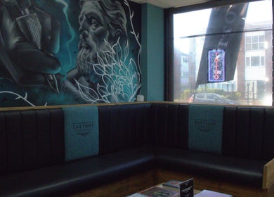 Artistic mural and seating at Liverpool Tattoos Orrell Park, Liverpool, England, GB, capturing a unique ambiance.