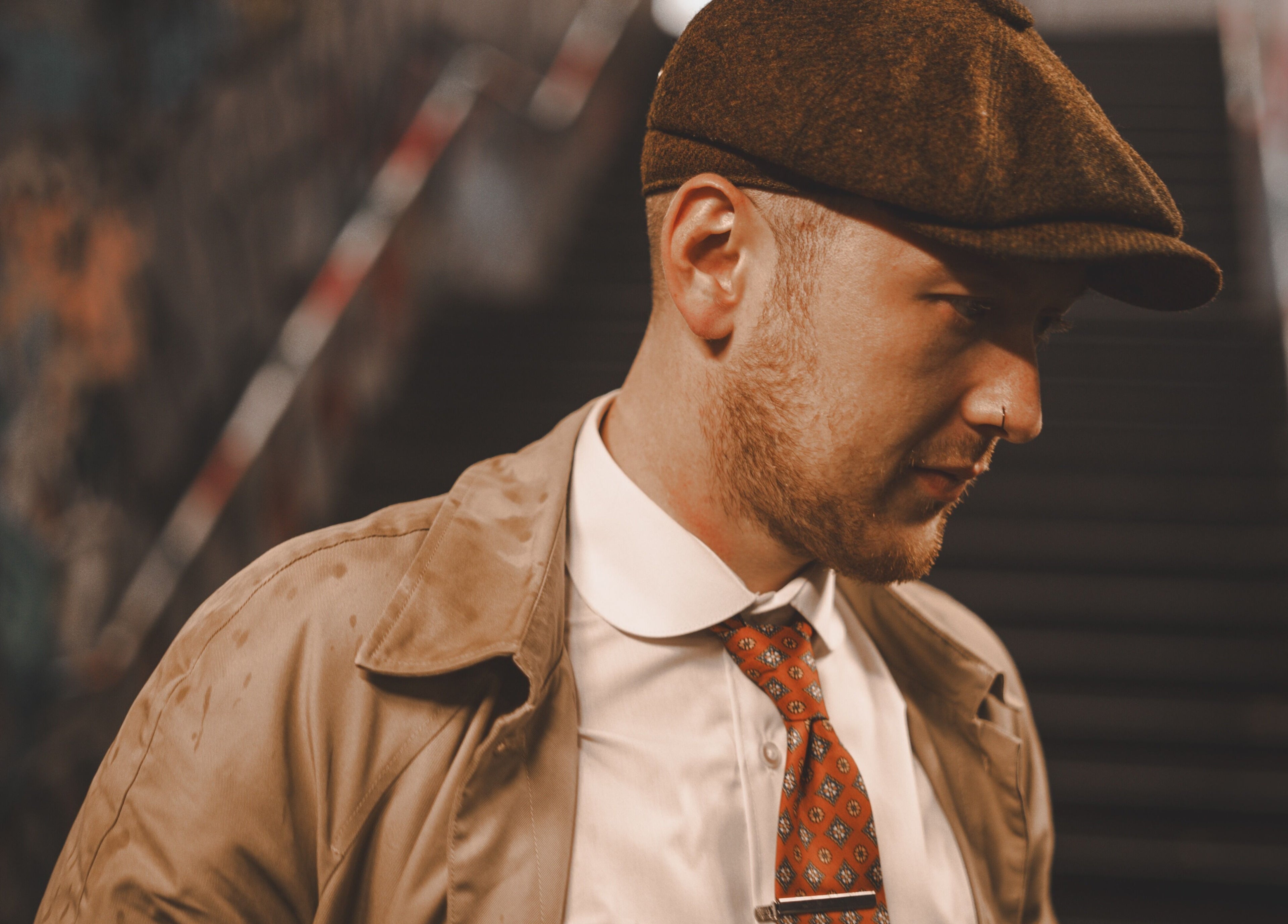 Stylish man in a hat and trench coat at Head Studio in Lisburn, Northern Ireland, GB.