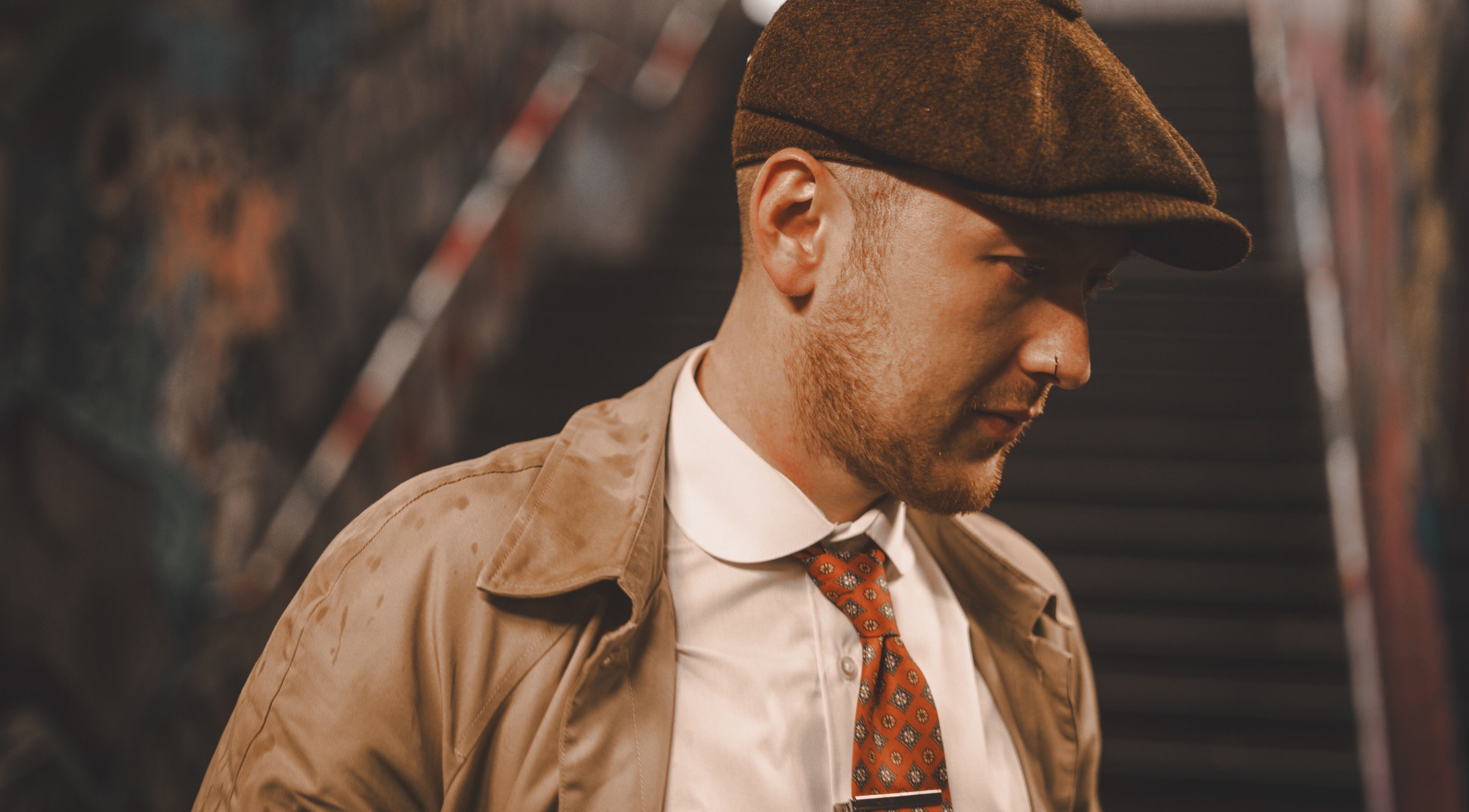 Stylish man in a hat and trench coat at Head Studio in Lisburn, Northern Ireland, GB.