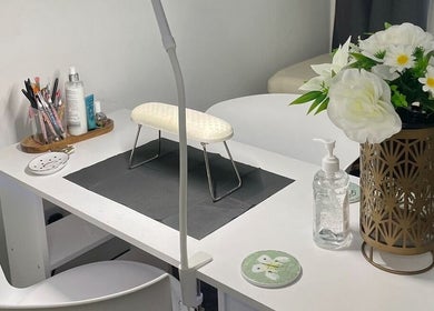 Stylish nail station at By Chlo in Sunderland, England, GB, featuring tools, flowers, and a modern chair.
