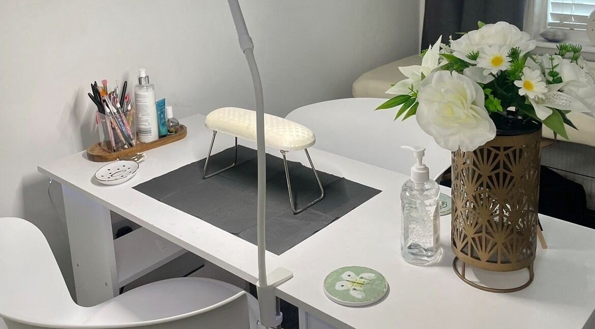Stylish nail station at By Chlo in Sunderland, England, GB, featuring tools, flowers, and a modern chair.