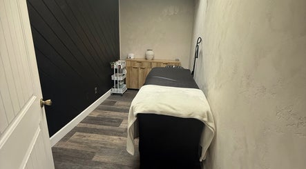 Calming treatment room at Bloom Lash & Esthetics, Pocatello, Idaho, US, featuring a massage table and cozy decor.