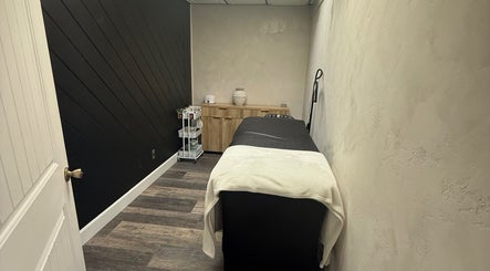 Cozy spa room at Bloom Lash & Esthetics in Pocatello, Idaho, US, featuring a treatment bed and elegant decor.
