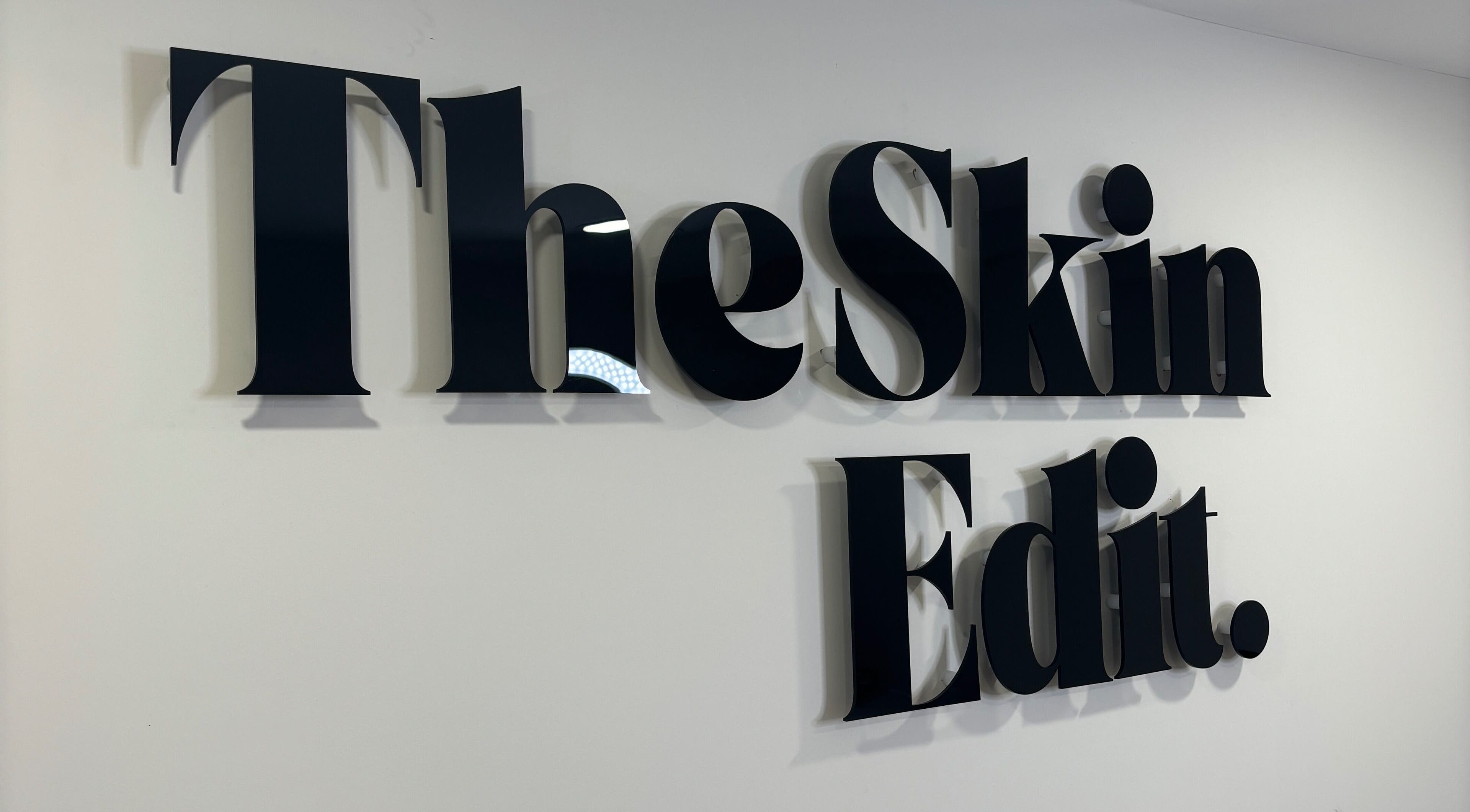 Sleek text logo of The Skin Edit on a wall in Hamilton, Scotland, GB.
