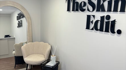 Elegant waiting area at The Skin Edit, Hamilton, Scotland, GB, featuring a cozy chair and decor.