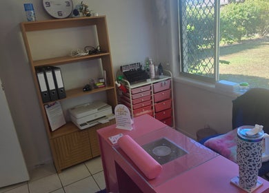 Elegant Essence in Annandale, Queensland, AU features a chic beauty workspace with a pink nail station.