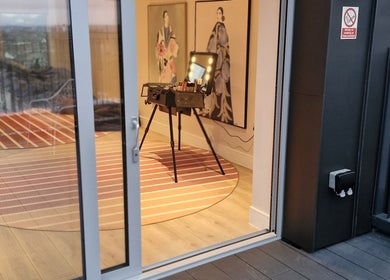 Elegant makeup station interior at Make Up by Niloo, London, GB, showcasing stylish decor and art.