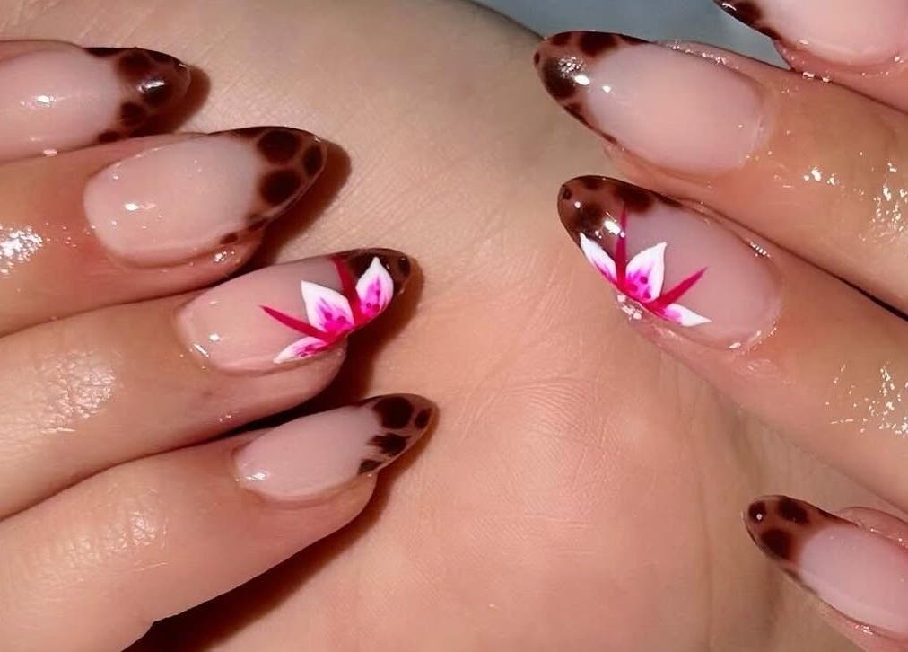 Stunning floral nail art at deznaillss in El Paso, Texas, US, featuring intricate designs and glossy finish.
