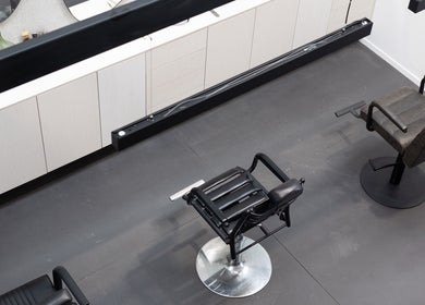Modern styling chairs at Drader Brows, Auckland, Auckland, NZ, showcasing sleek salon ambiance.