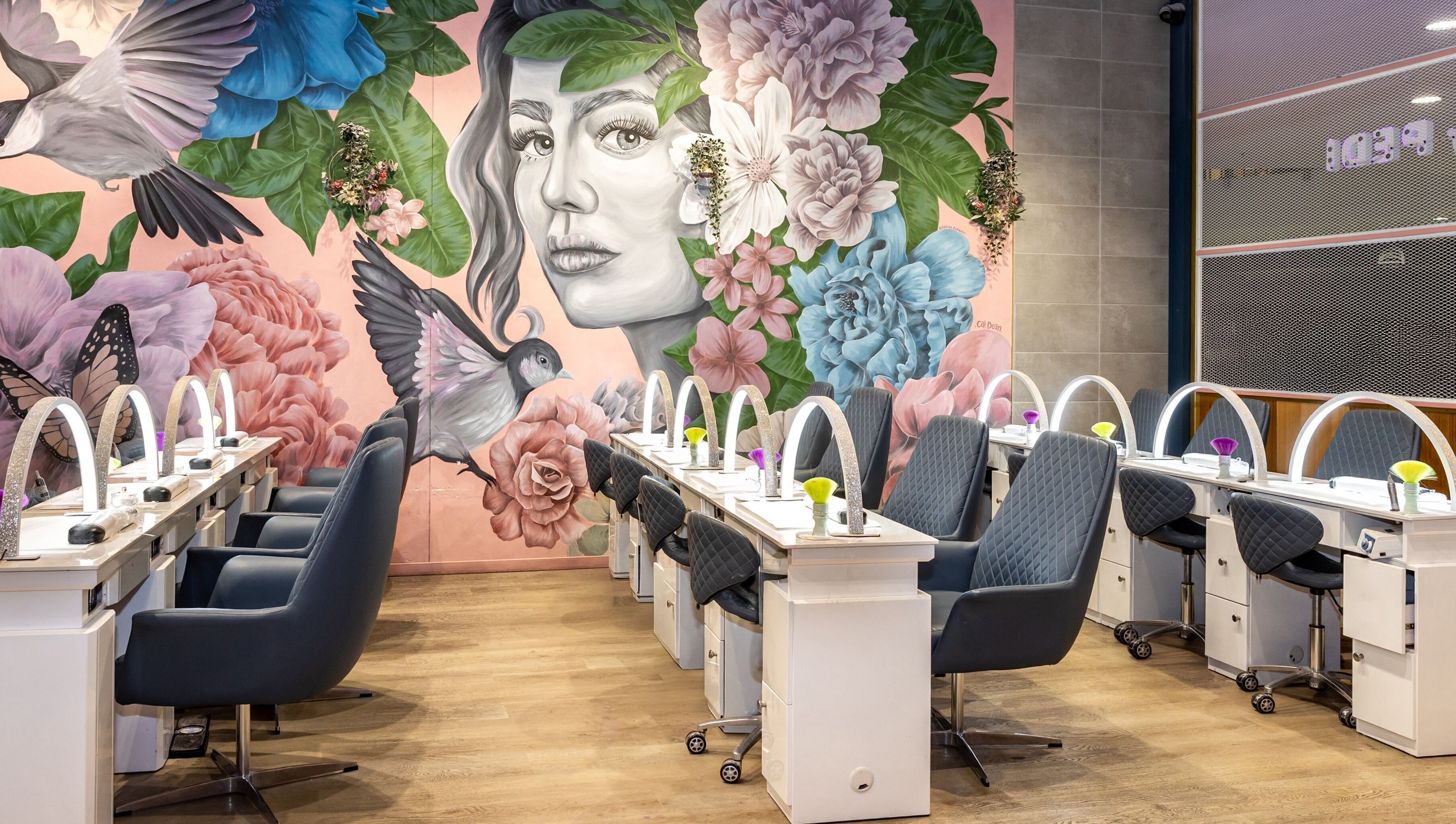 Interior of Mani Pedi Nail Salon Colonnades in Noarlunga Centre, South Australia, AU with vibrant floral mural.