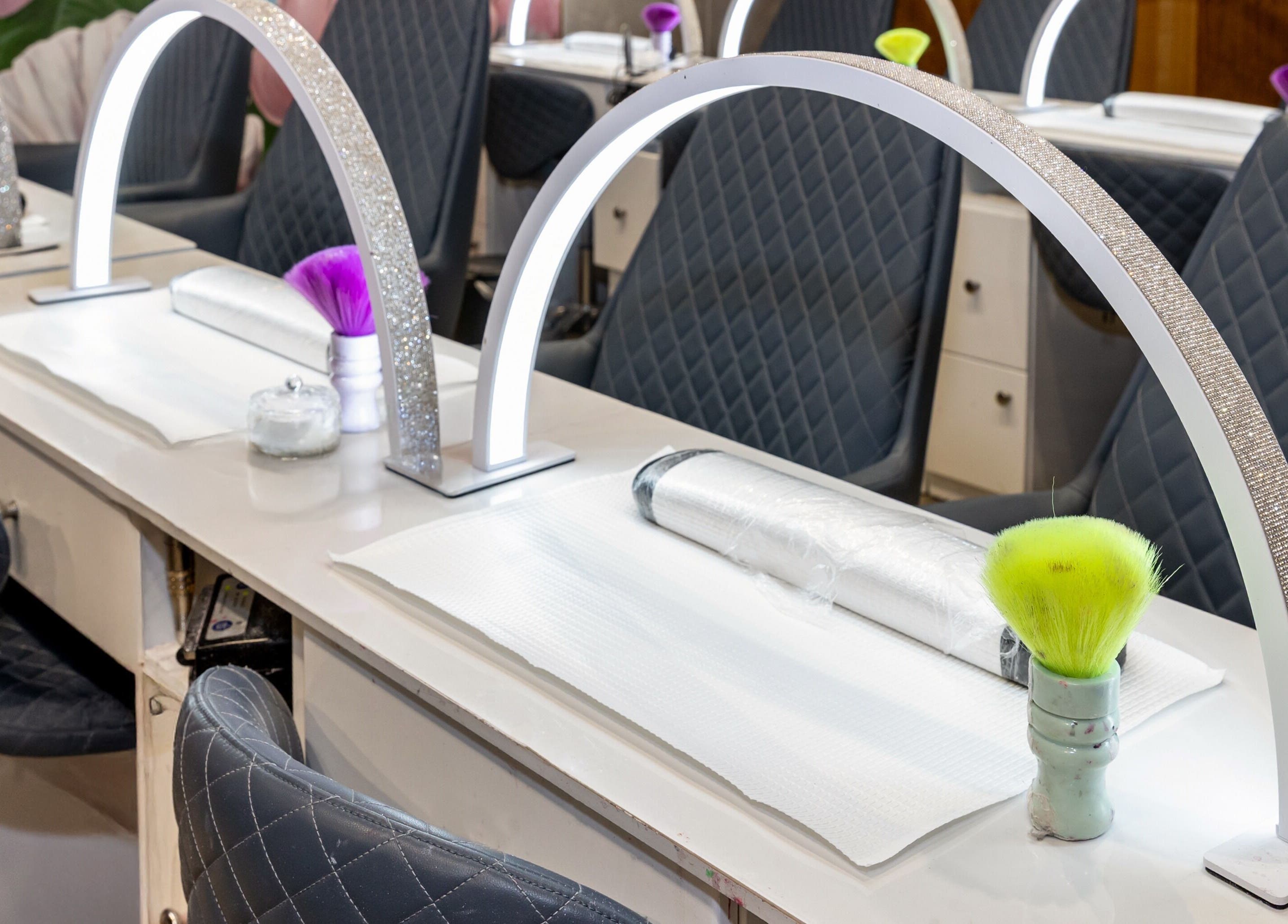 Nail stations at Mani Pedi Nail Salon Colonnades, Noarlunga Centre, South Australia, AU with chic seating.