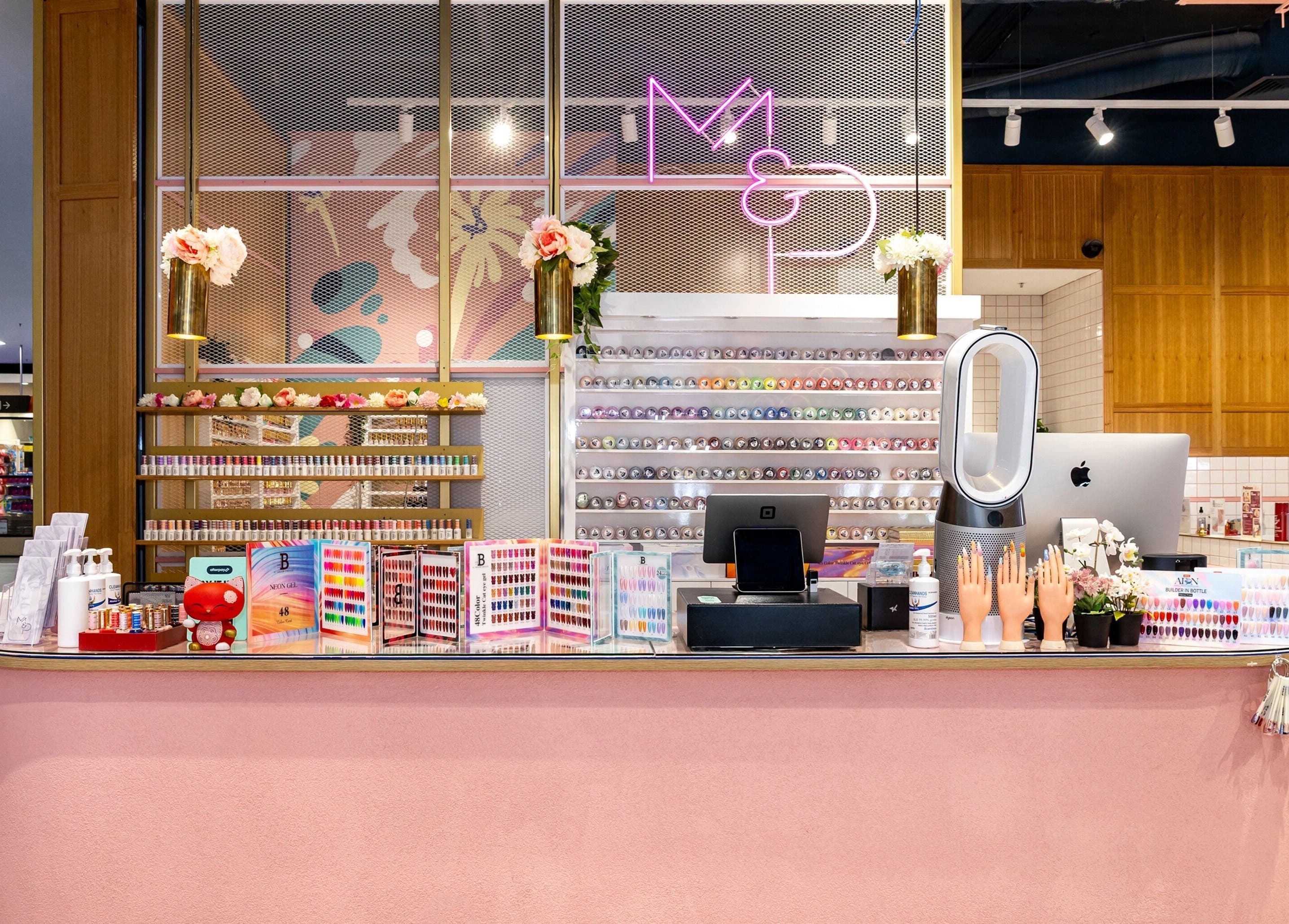 Mani Pedi Nail Salon Colonnades in Noarlunga Centre, South Australia, AU features a chic pink reception area.