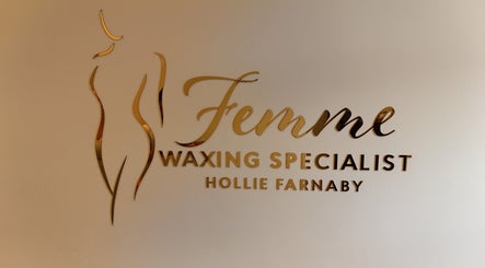 Femme Waxing Specialist Hollie Farnaby logo in Leeds, England, GB with elegant gold lettering on a light wall.