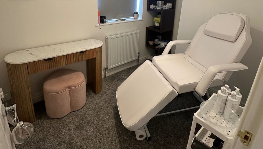 Relaxing treatment room at EQU Aesthetics, Lymm, England, GB, featuring a reclining chair and elegant decor.