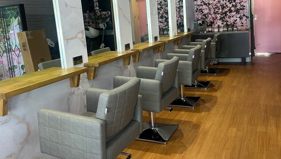 Modern salon interior at Hair by the Scissor Sisters, Nottingham, England, GB with stylish chairs and mirrors.