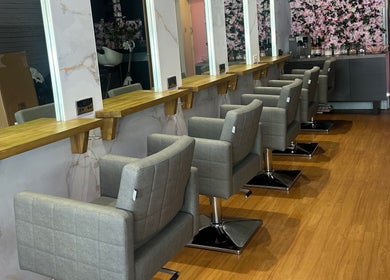 Modern salon interior at Hair by the Scissor Sisters, Nottingham, England, GB with stylish chairs and mirrors.