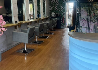 Chic interior of Hair by the Scissor Sisters, Nottingham, England, GB with modern chairs and floral decor.