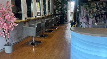 Chic interior of Hair by the Scissor Sisters, Nottingham, England, GB with modern chairs and floral decor.