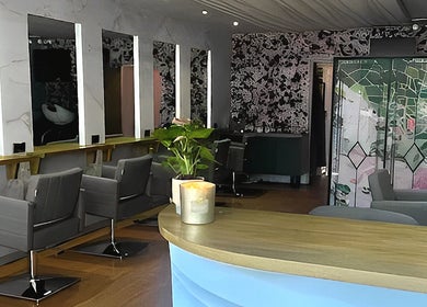 Interior of Hair by the Scissor Sisters in Nottingham, England, featuring stylish chairs and modern decor.