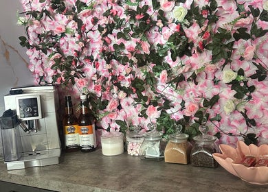 Coffee station with pink floral backdrop at Hair by the Scissor Sisters, Nottingham, England, GB.