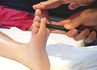 Foot massage tool in use at Cheeva thai masszázs, Budapest, Magyar, HU enhancing relaxation and wellness.