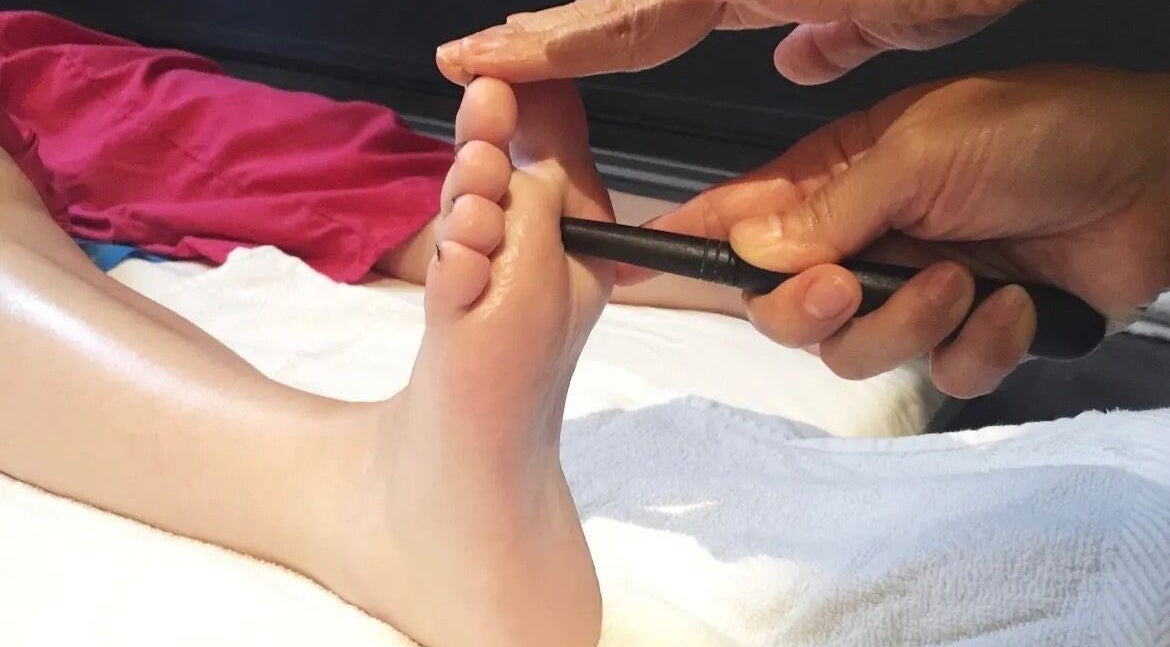 Foot massage tool in use at Cheeva thai masszázs, Budapest, Magyar, HU enhancing relaxation and wellness.