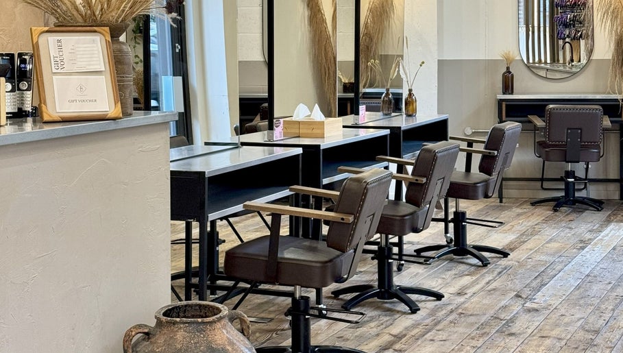 Chic interior of The Holistic Project in London, England, GB featuring stylish styling stations and rustic decor.