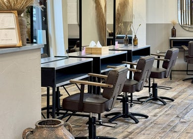 Chic interior of The Holistic Project in London, England, GB featuring stylish styling stations and rustic decor.