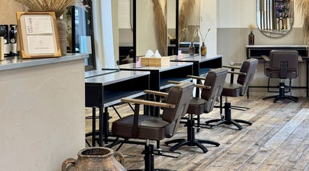 Chic interior of The Holistic Project in London, England, GB featuring stylish styling stations and rustic decor.