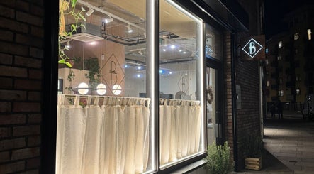 The Holistic Project's elegant exterior in London, England, GB, featuring modern lighting and stylish design.